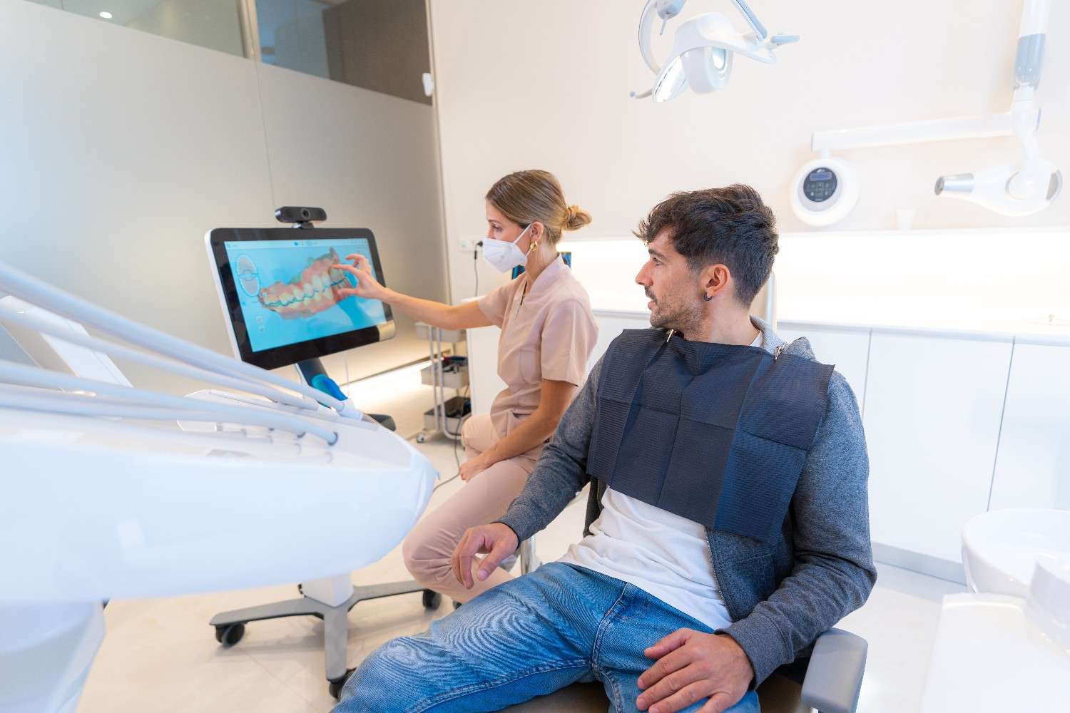 Dentist explaining a cosmetic dental procedure using digital imaging.