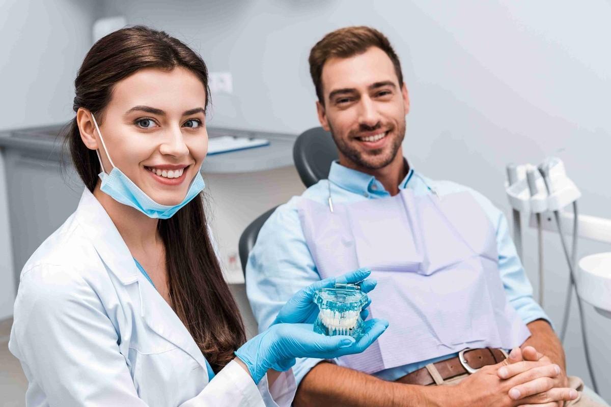Dentist showing a patient clear aligners during an Invisalign consultation in a dental office